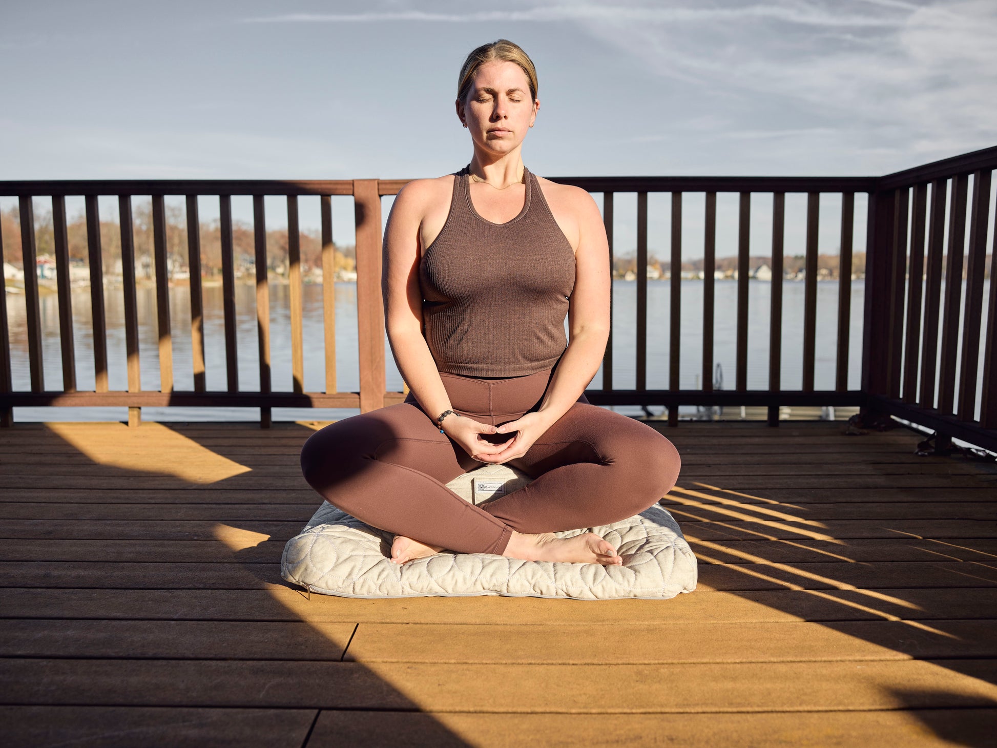 woman meditating on zafu and zabuton